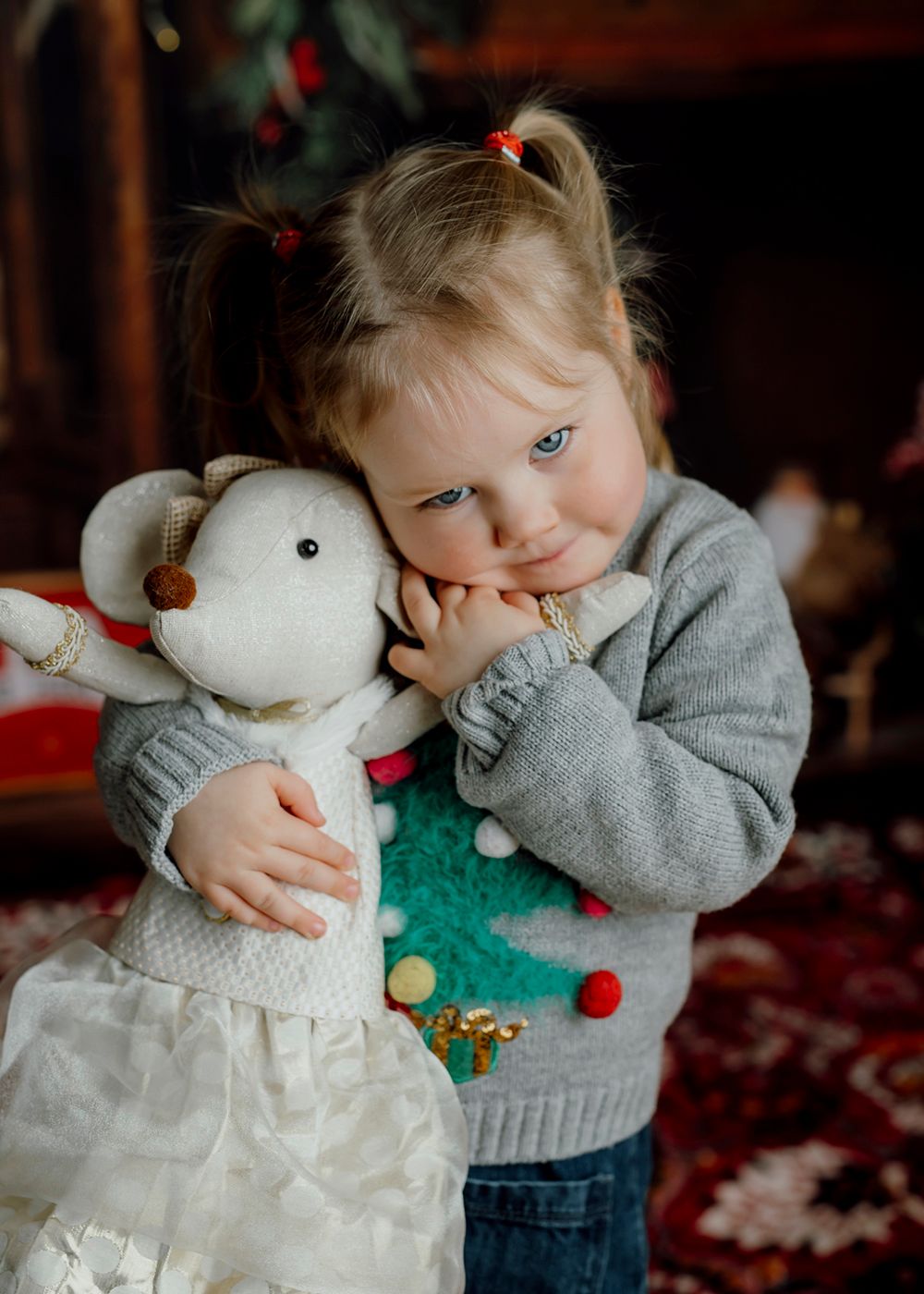 little girl hugging mouse toy