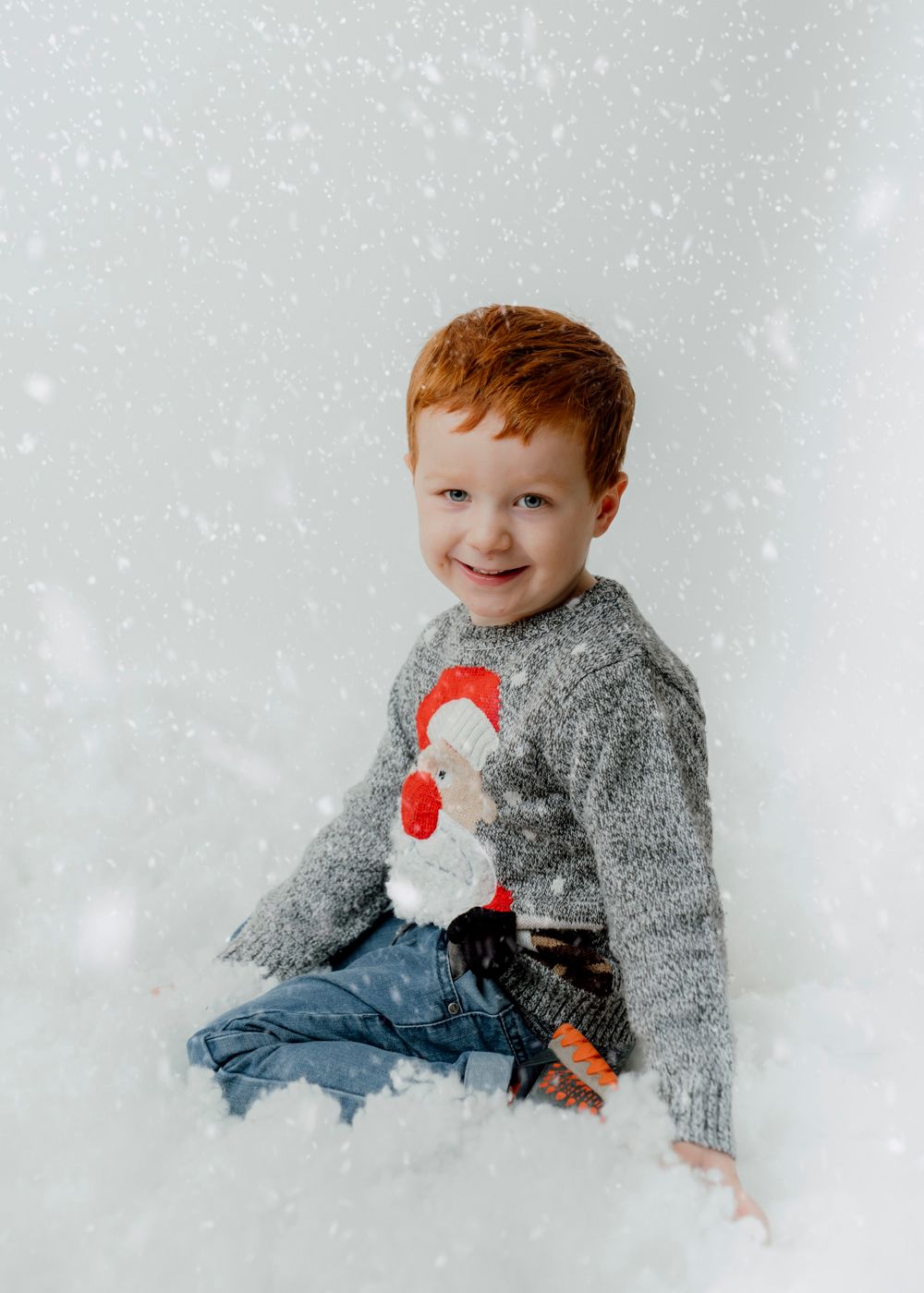red hair boy playing in the snow