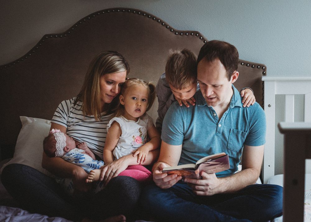 family reading together newborn session Seattle