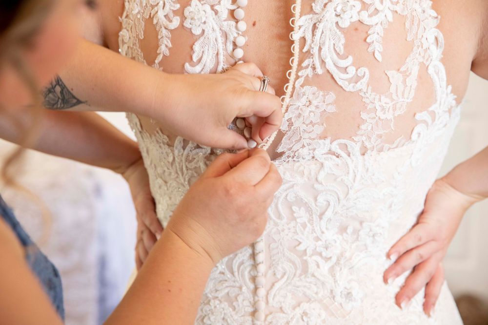 Bride getting dressed at Fallen Oaks Estate