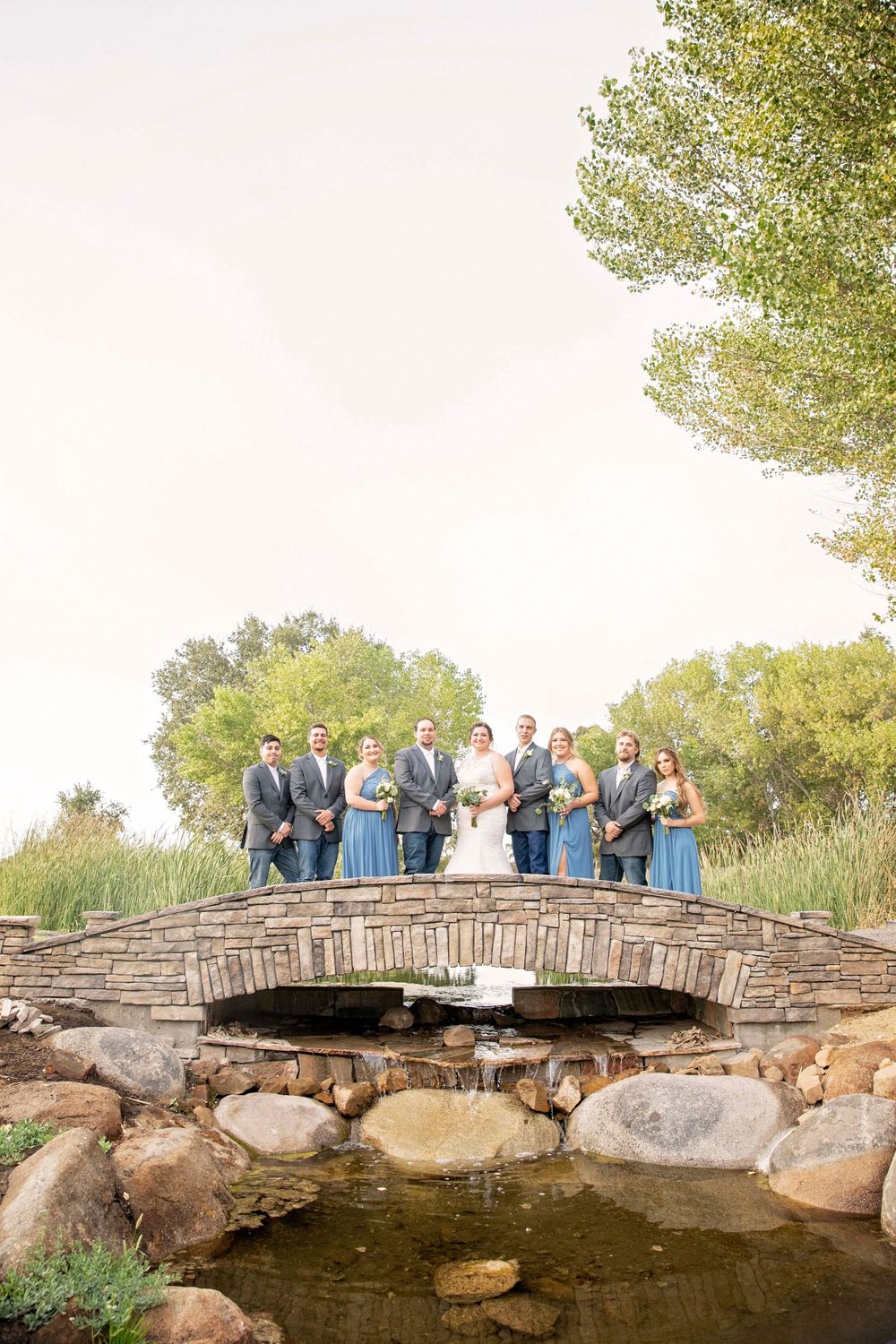 Wedding party on a bridge at Fallen Oaks Estate