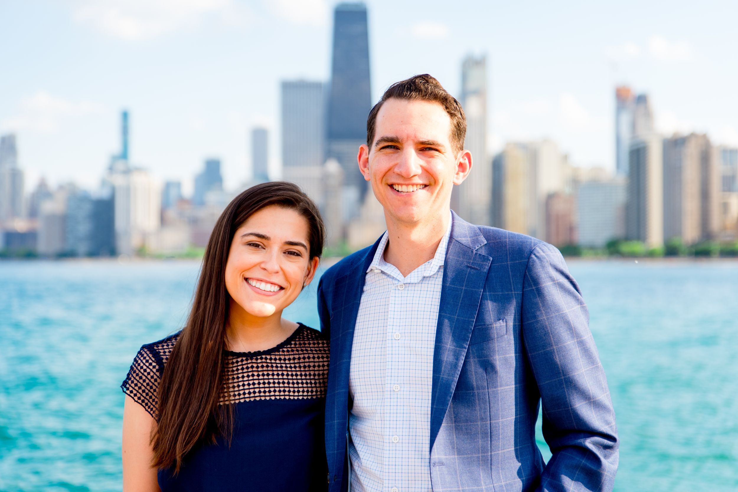 man and woman smiling in front of Hancock tower after North Avenue Beach proposal