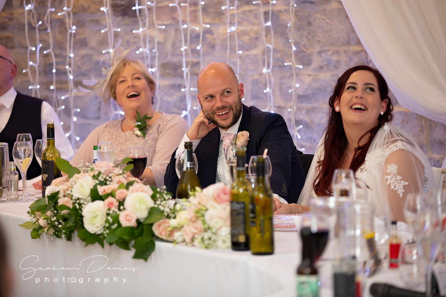 groom laughing during the speeches at wedding breakfast at St Tewdrics House