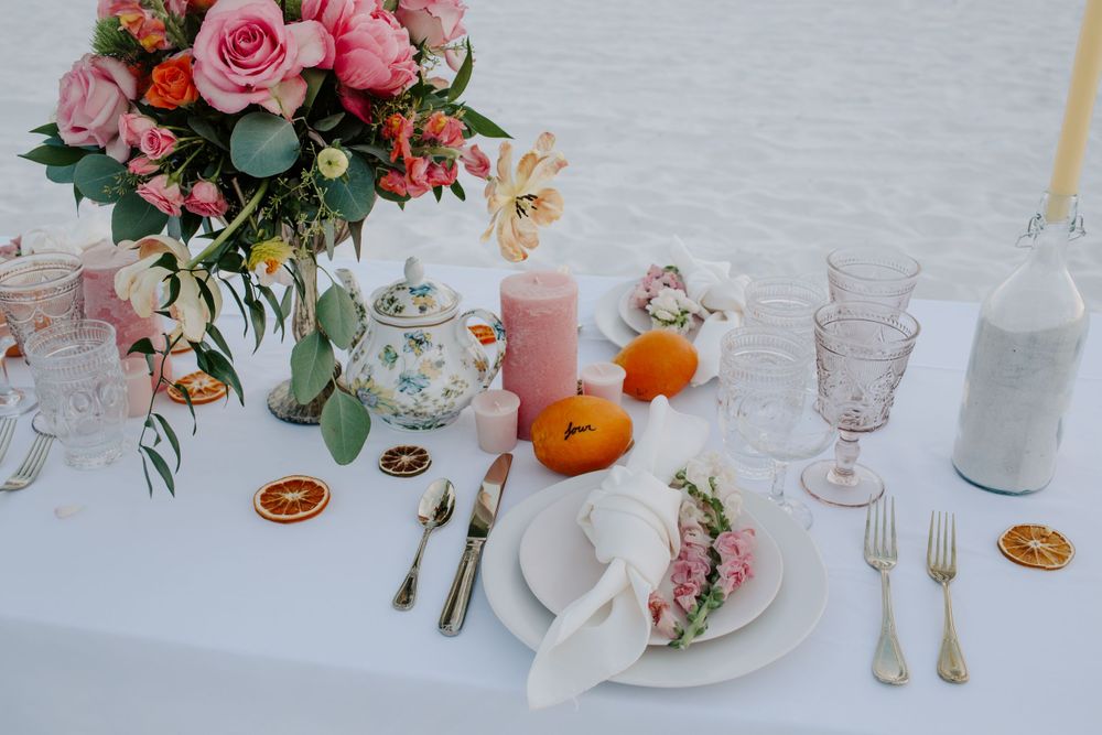 view looking down at a citrus themed wedding table during a beachside elopement