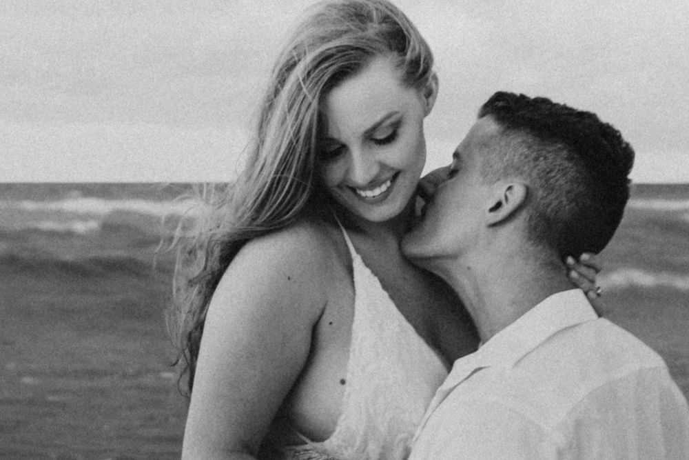 man going in to kiss his bride on the neck during their adventurous elopement