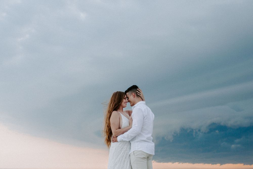 couple resting their foreheads together during their beach adventurous elopement