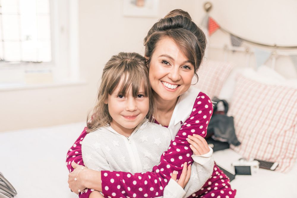 Two people sharing joyful moment while wearing polka dot and casual clothing.