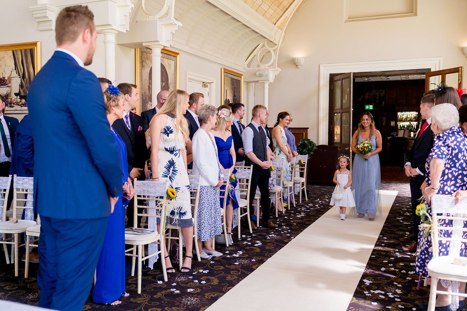 flower girl walking down the aisle