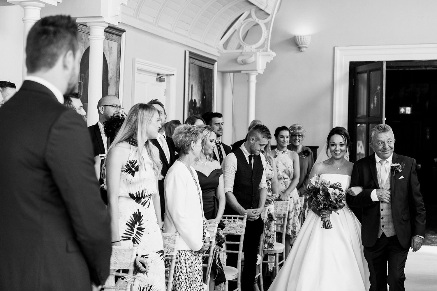 black and white bride walking down aisle