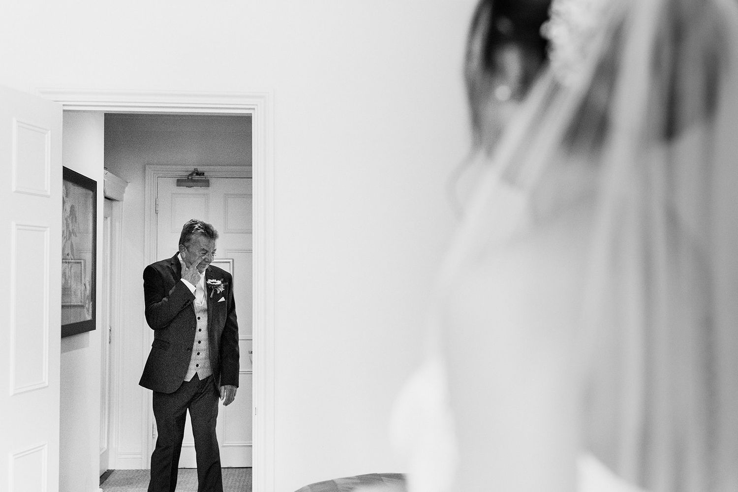 black and white photo of father seeing bride for first time