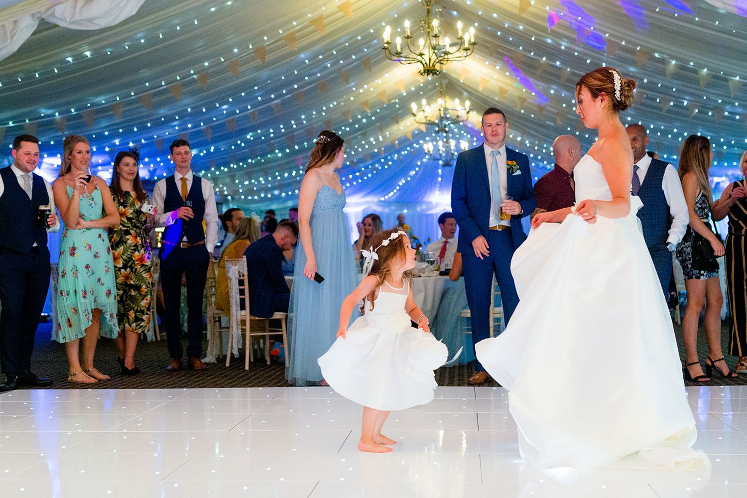 flower girl and bride dancing