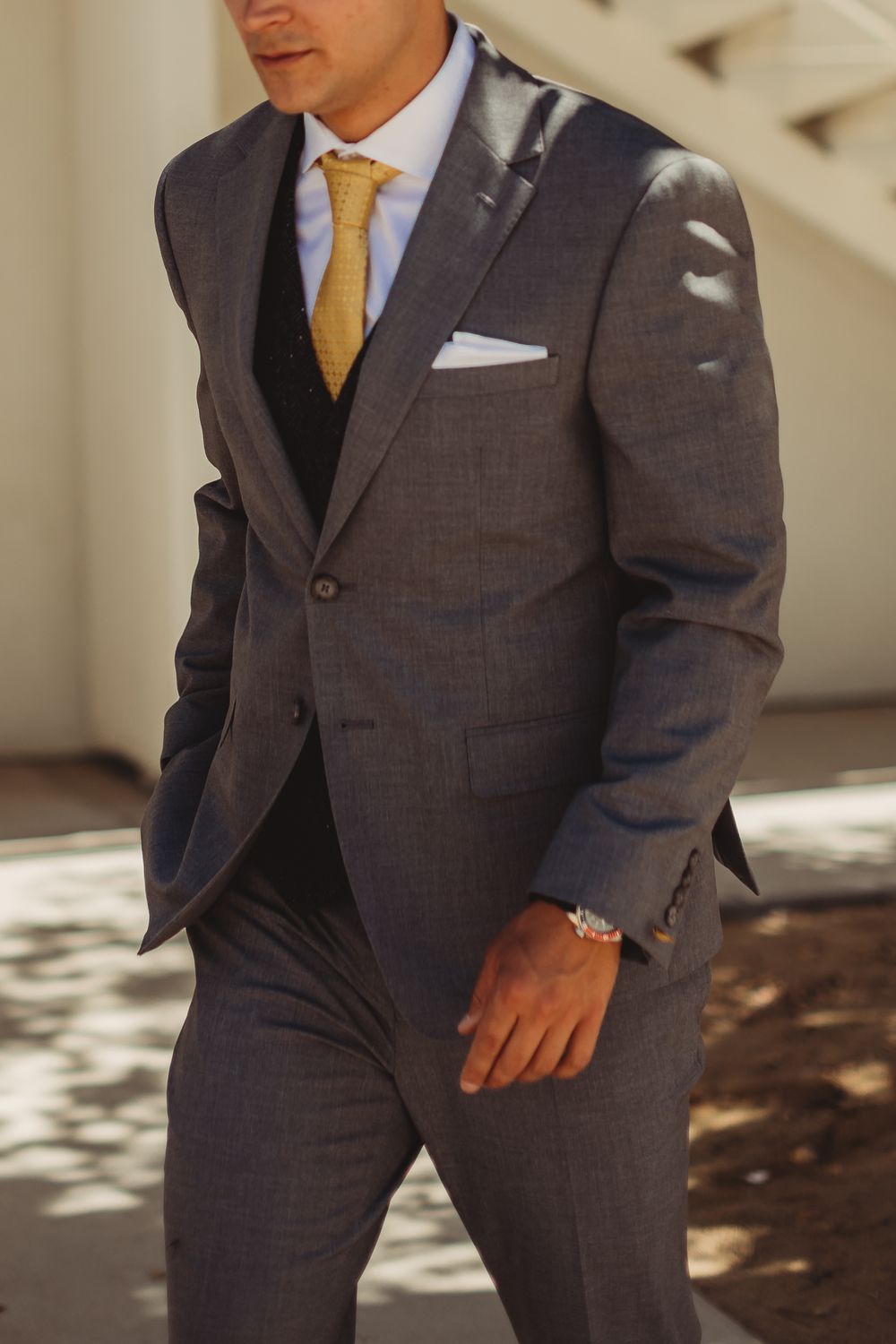 Wedding Fashion photography of a groom walking to the venue in his wedding tux