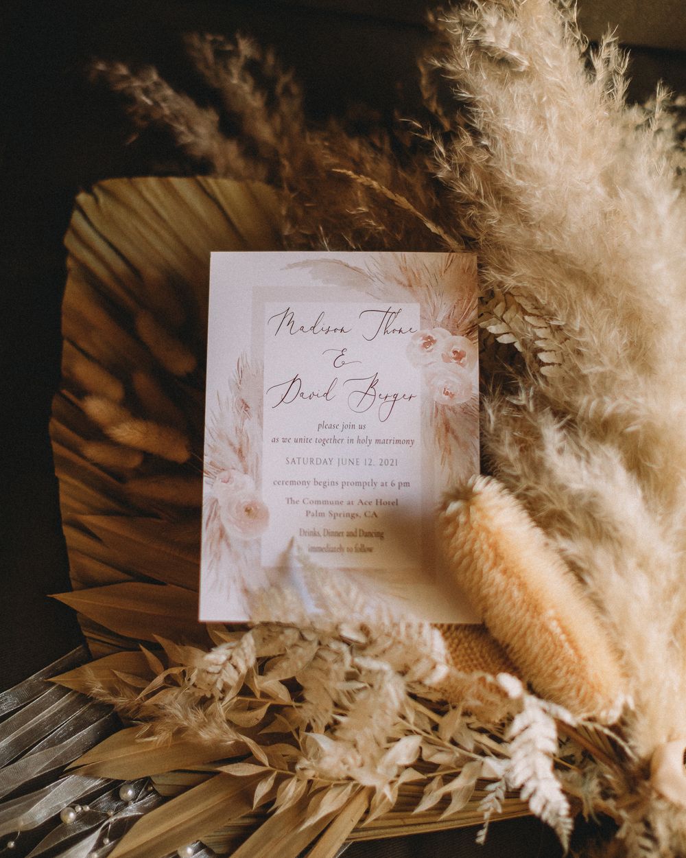Flat lay photography of wedding invite and the brides bouquet