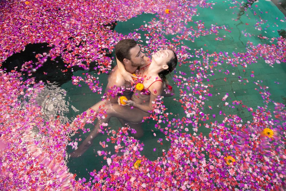 romantic moment of a couple surrounded by floating flowers
