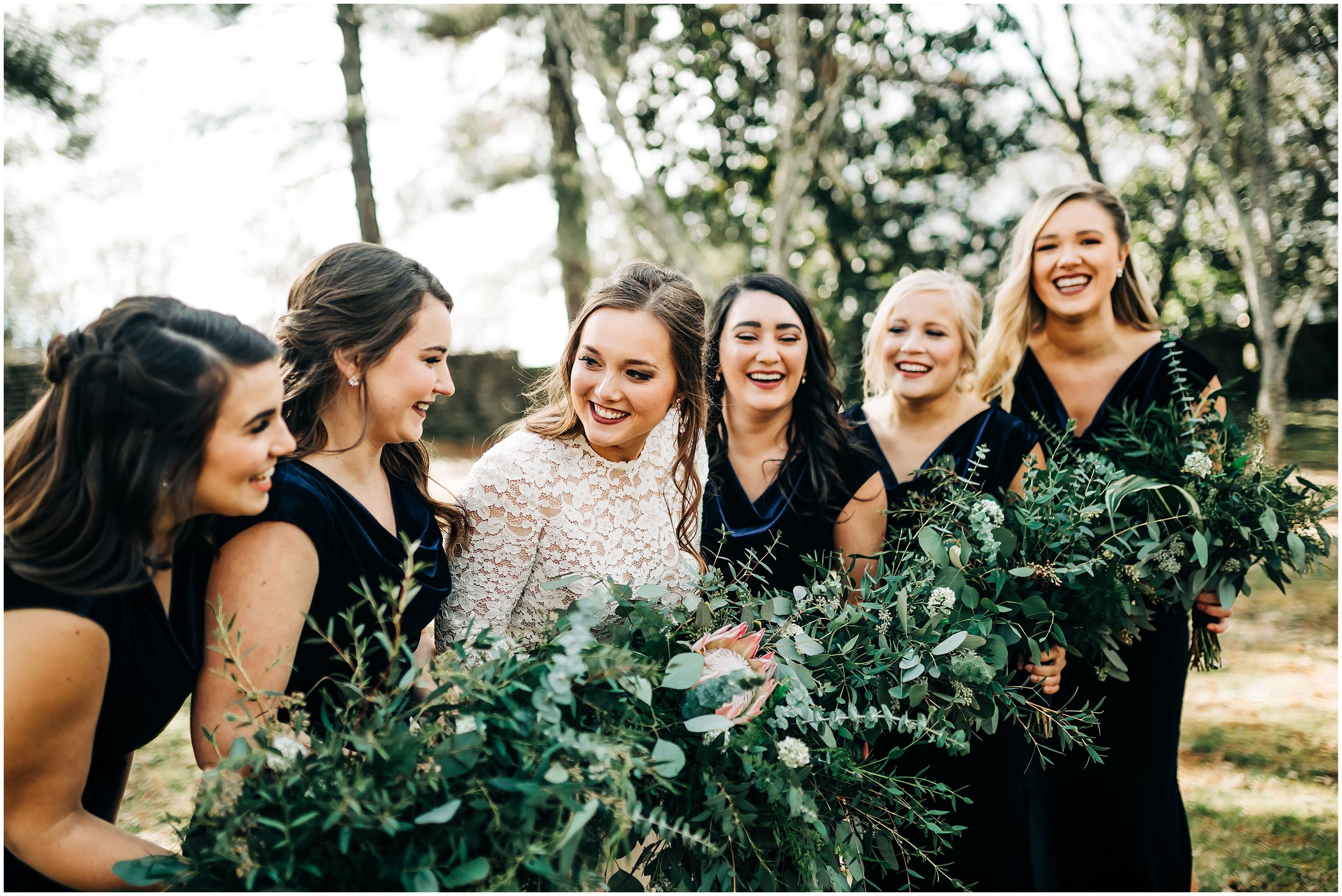 Bride laughing with bridesmaids