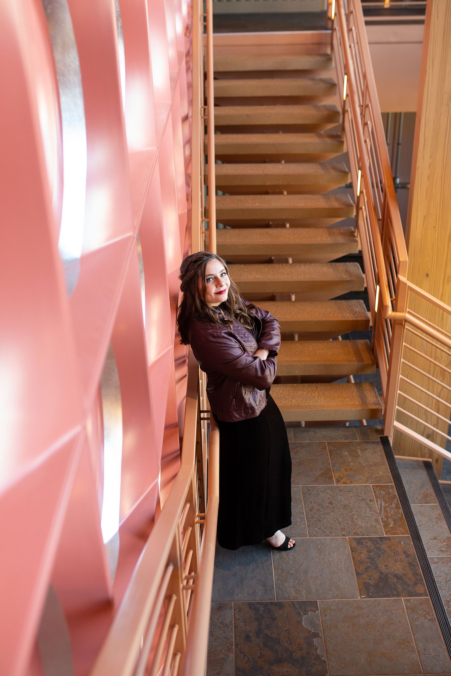 senior girl in staircase with coral geometric background