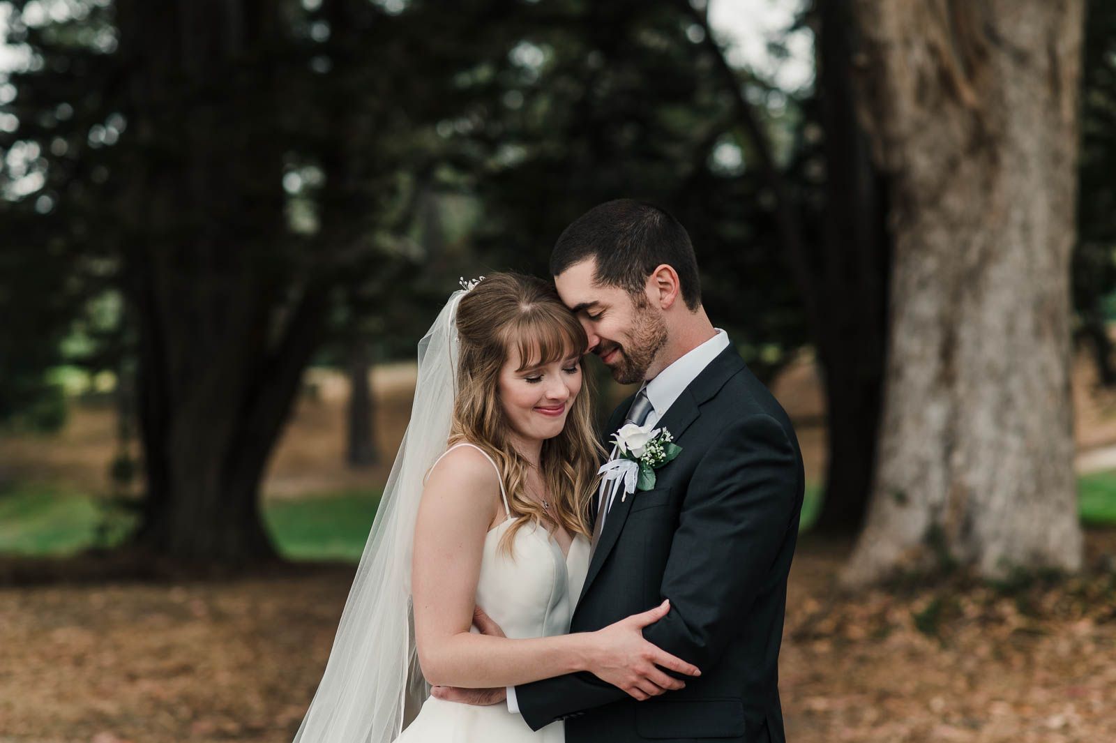 close up portrait of bride and groom embracing