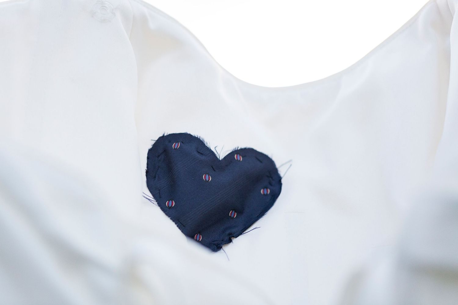 A piece of the bride's father's tie cut in the shape of a heart, sewn into the inside of her wedding dress.