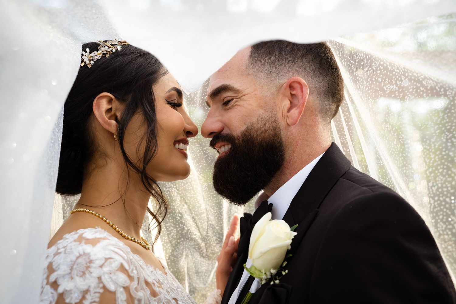 Bride groom under veil on wedding day