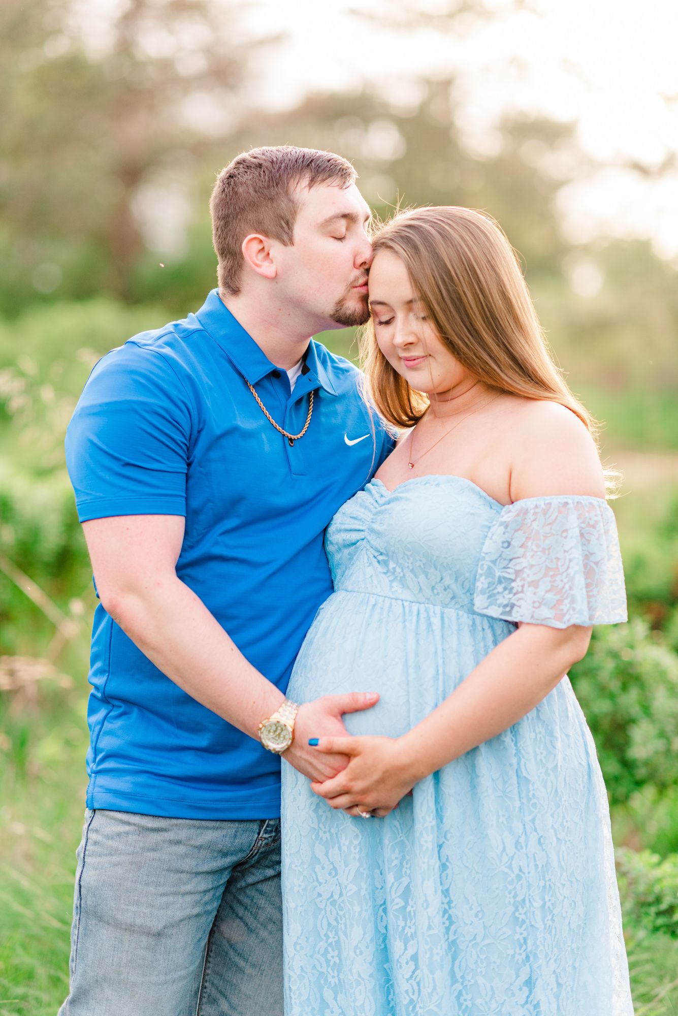 Maternity session with couple in field in golden hour sunlight at Moraine State Park, Pennsylvania