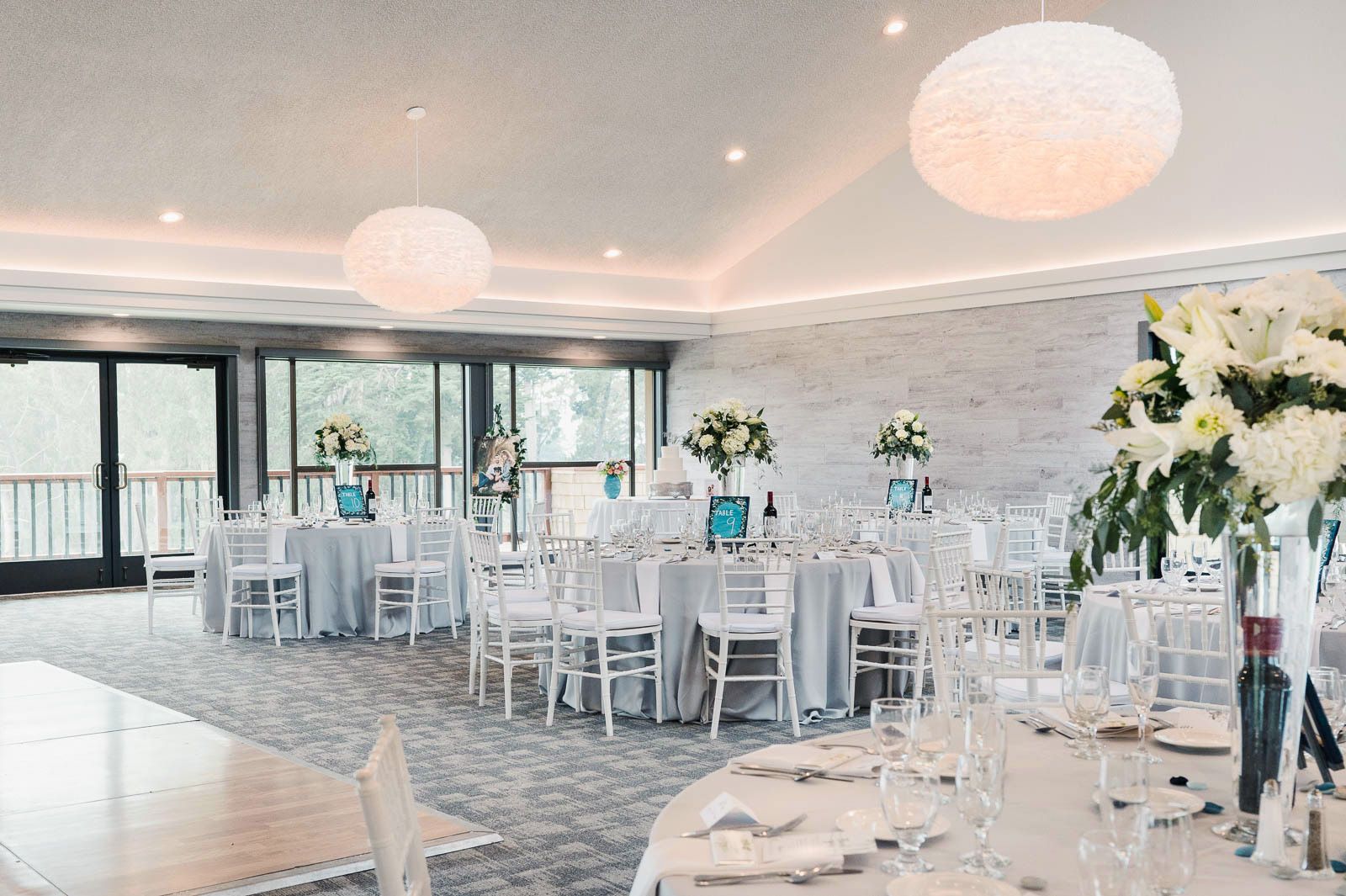 Inside the newly renovated monarch room of Seascape Golf club with reception decor setup in white and blue