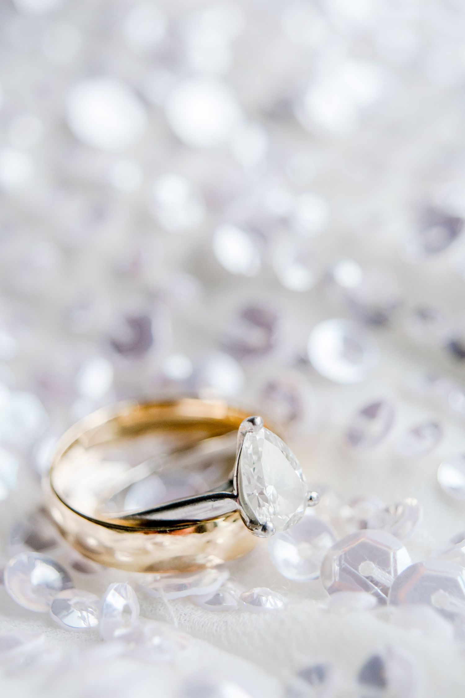 wedding bands stacked on top of each other on sequin wedding dress