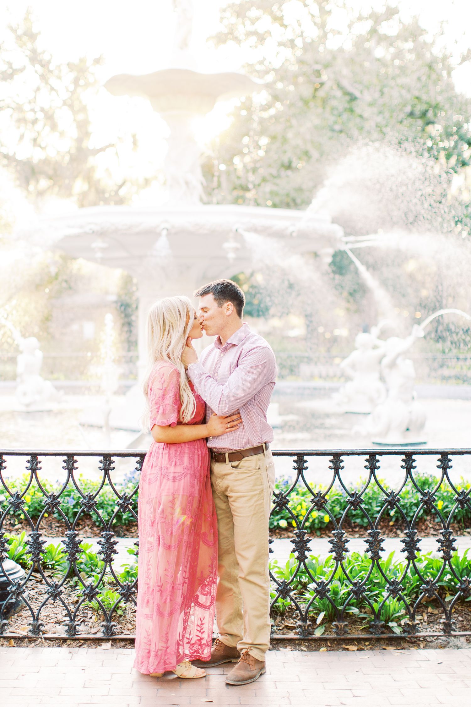 couple kisses in front of the fountain in forsyth park in downtown savannah, ga