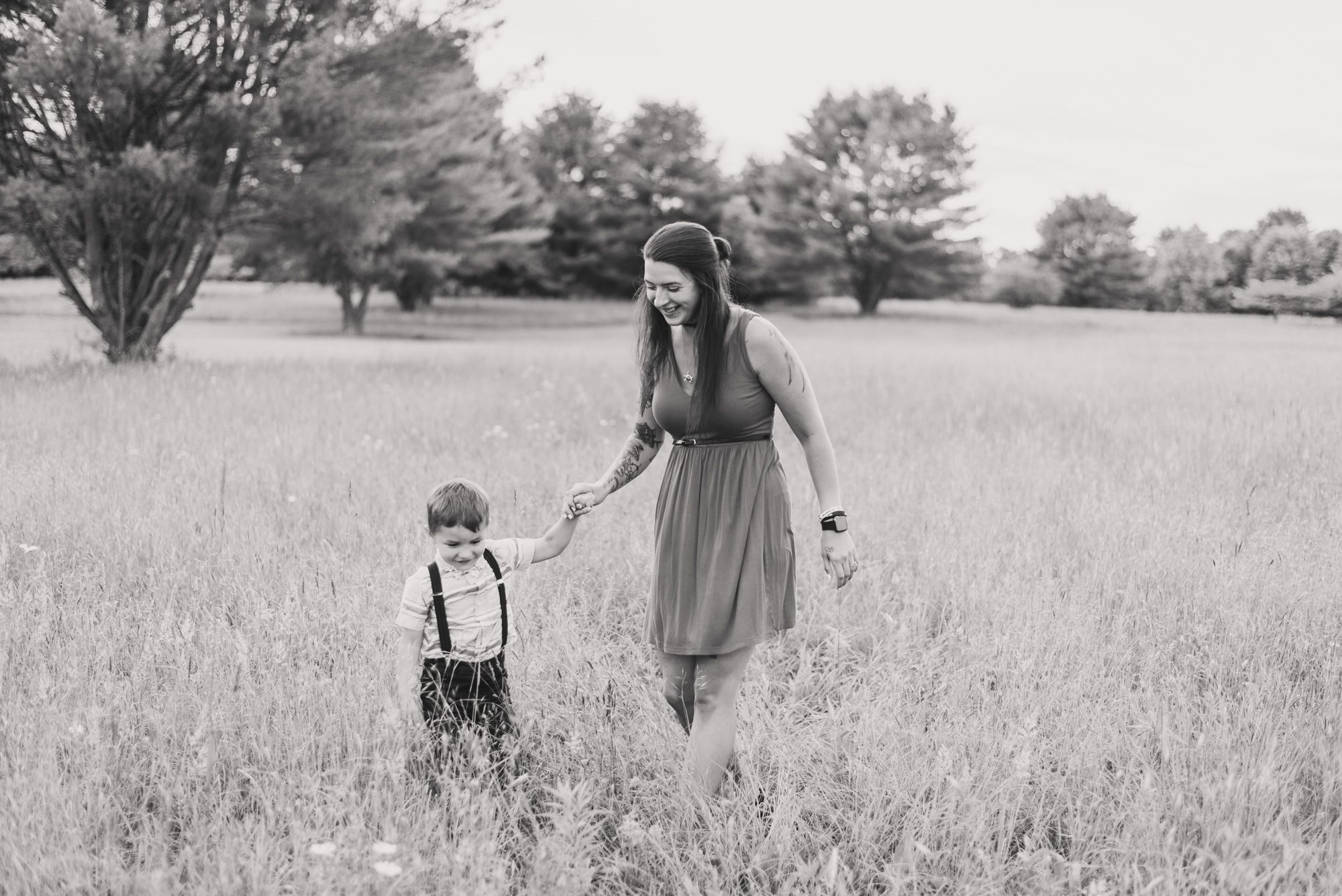 Mother and son running through field in black and white in Clarion Pennsylvania