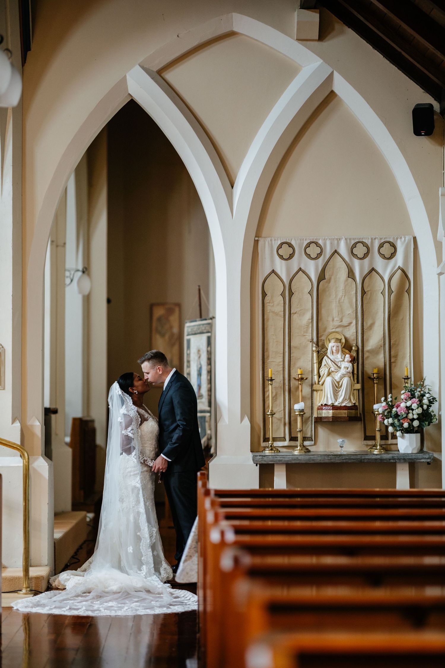 Bride and Groom posing at a cathedral church in Hamilton