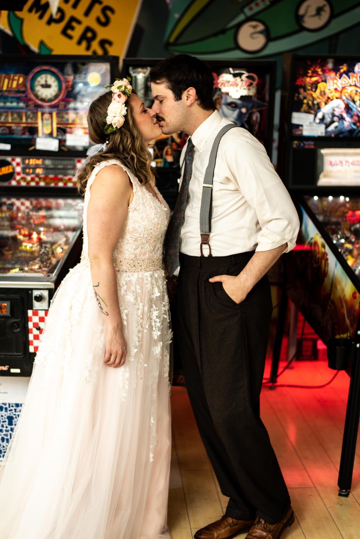 just married couple in front of a pinball machine at Superelectric Pinball in Cleveland