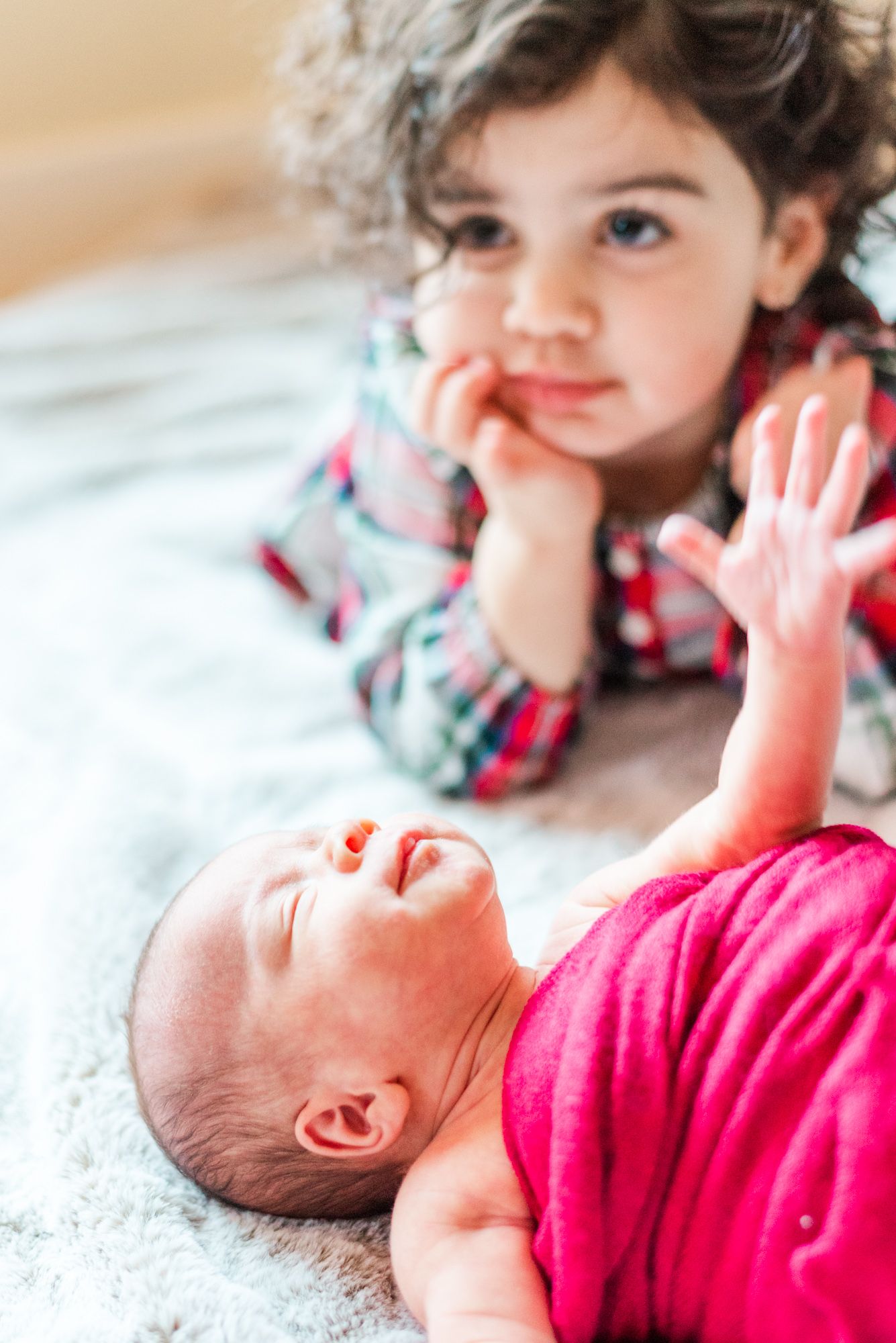 Big sister looking at newborn baby in Pittsburgh, Pennsylvania