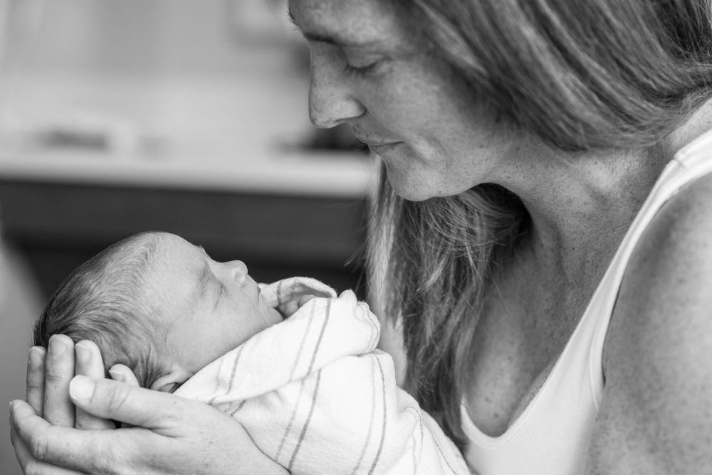 First moments with newborn baby captured in a Fresh 48 session by Heidi Harting Photography in Plymouth, MA