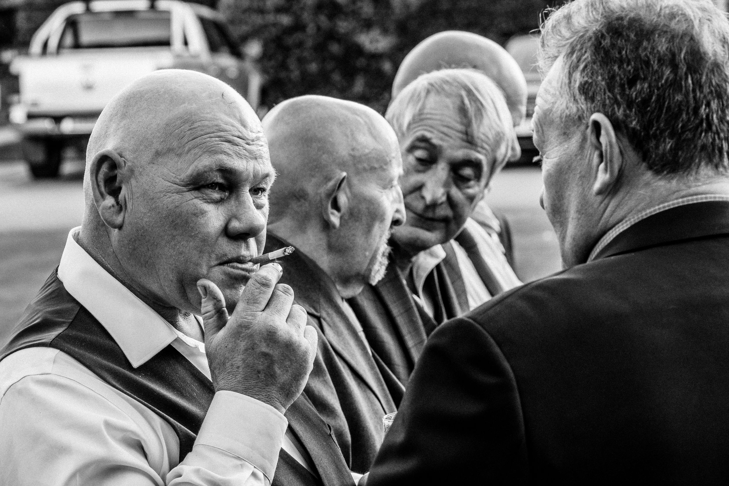 Black and white image of male guests during wedding reception in Yorkshire