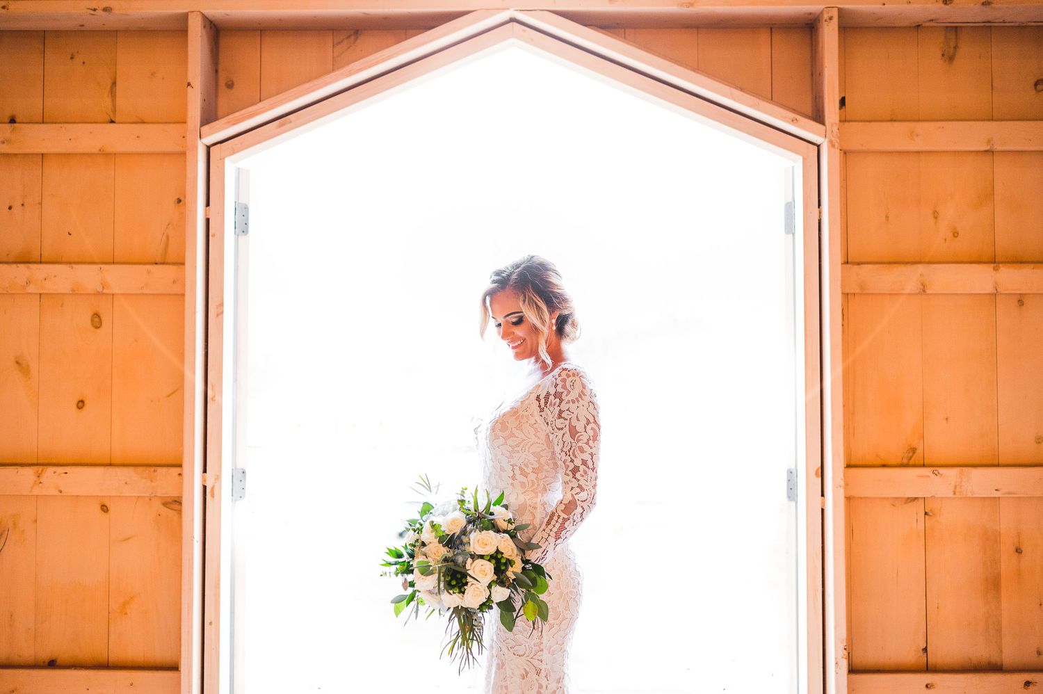 bridal portrait in front of barn deck at Edel Haus alpaca farm