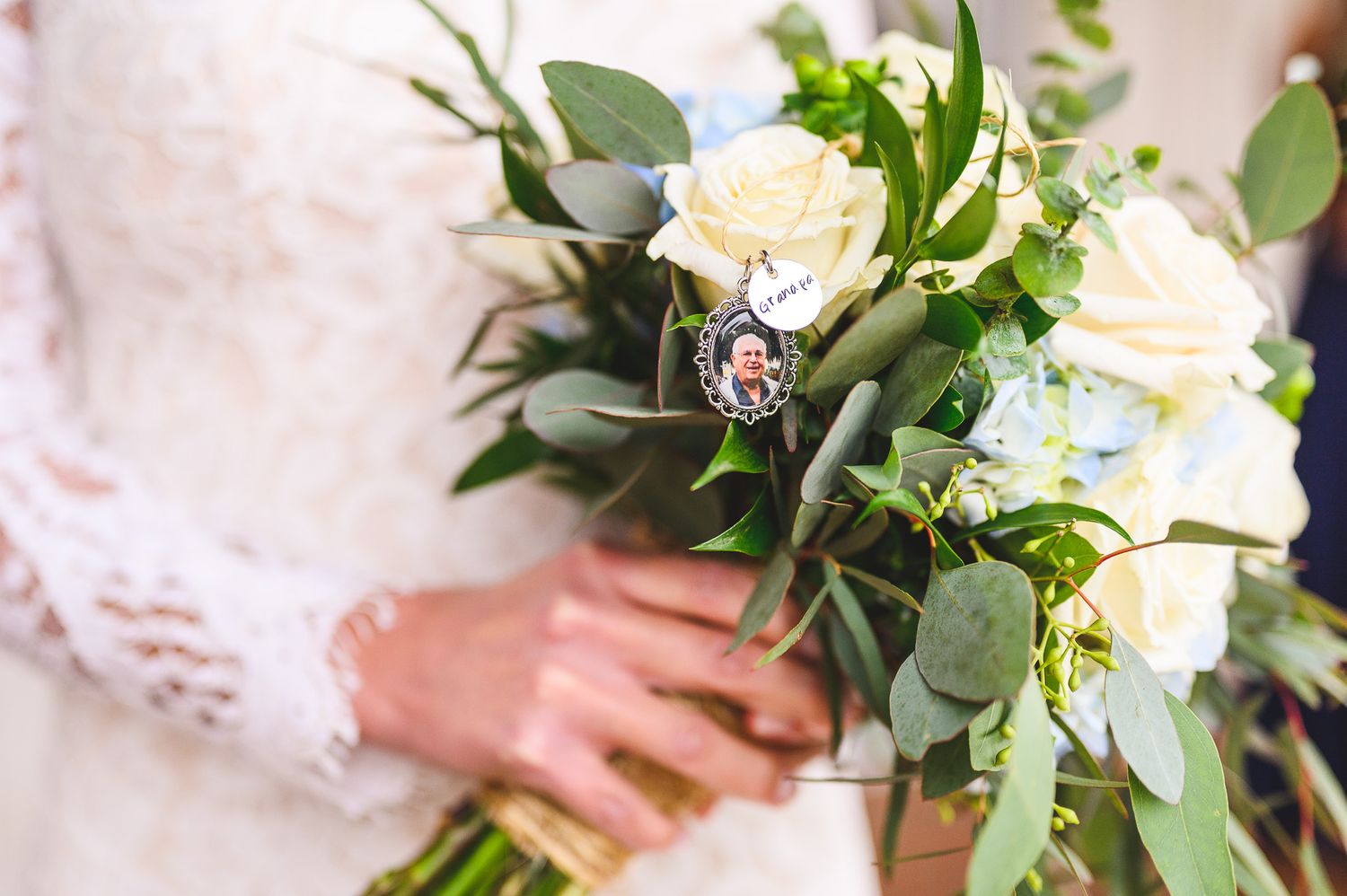 closeup of bouquet of flowers with photo of dad charm