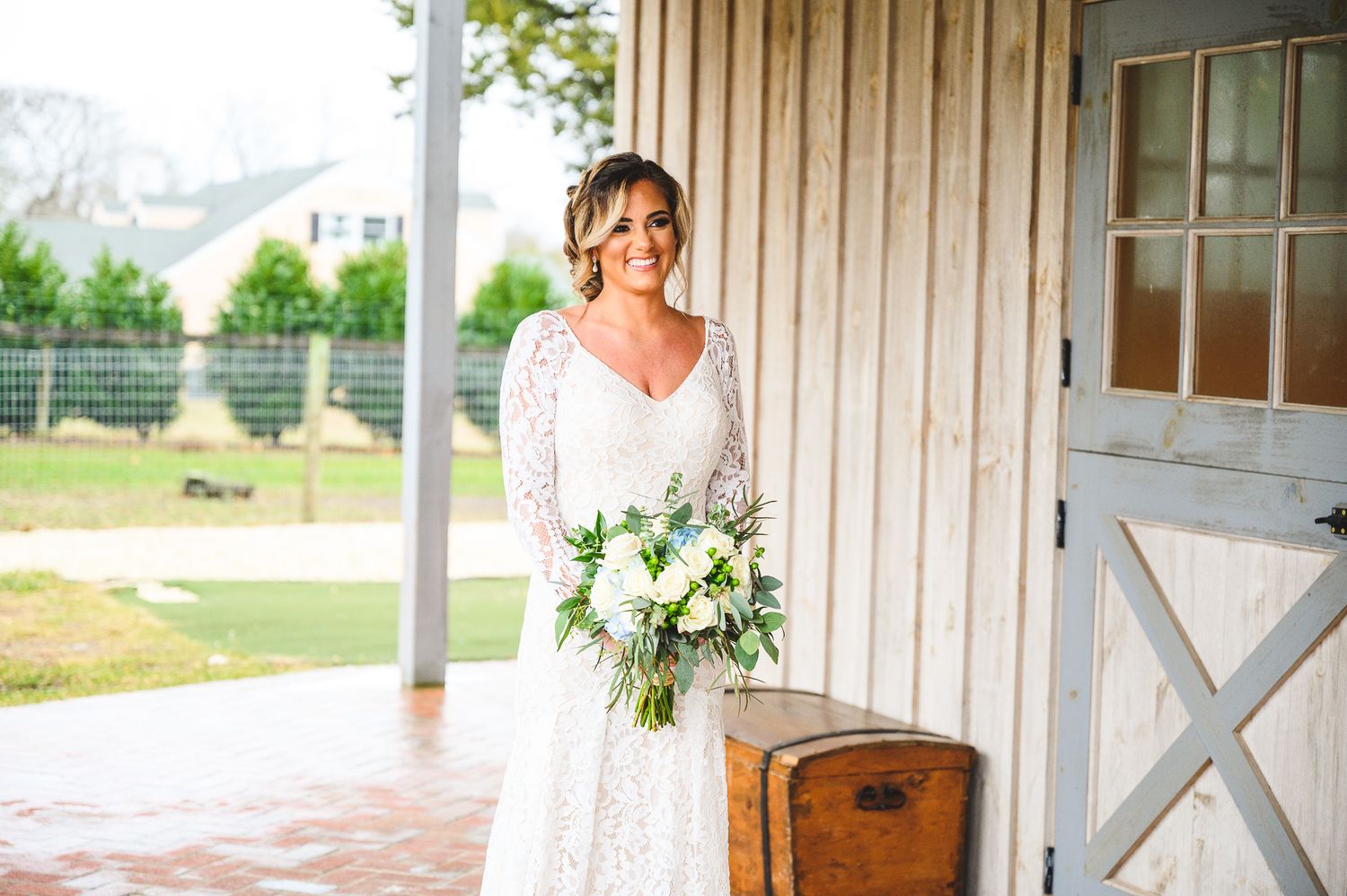 bride smiling in white wedding dress during first look