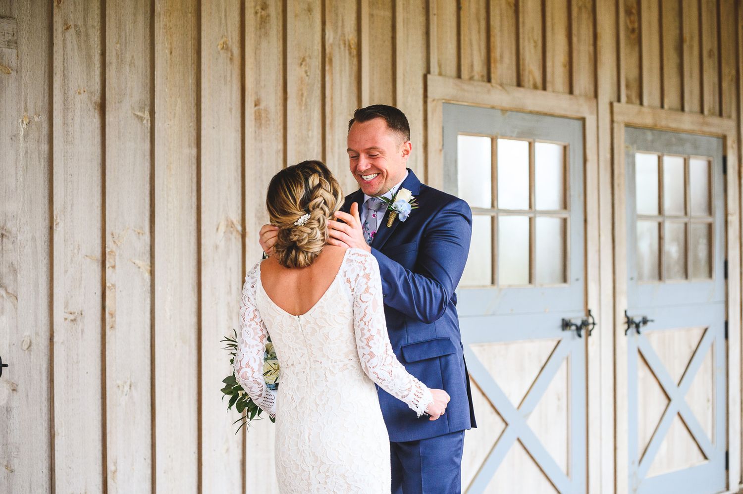 groom bringing bride in for kiss during the first look