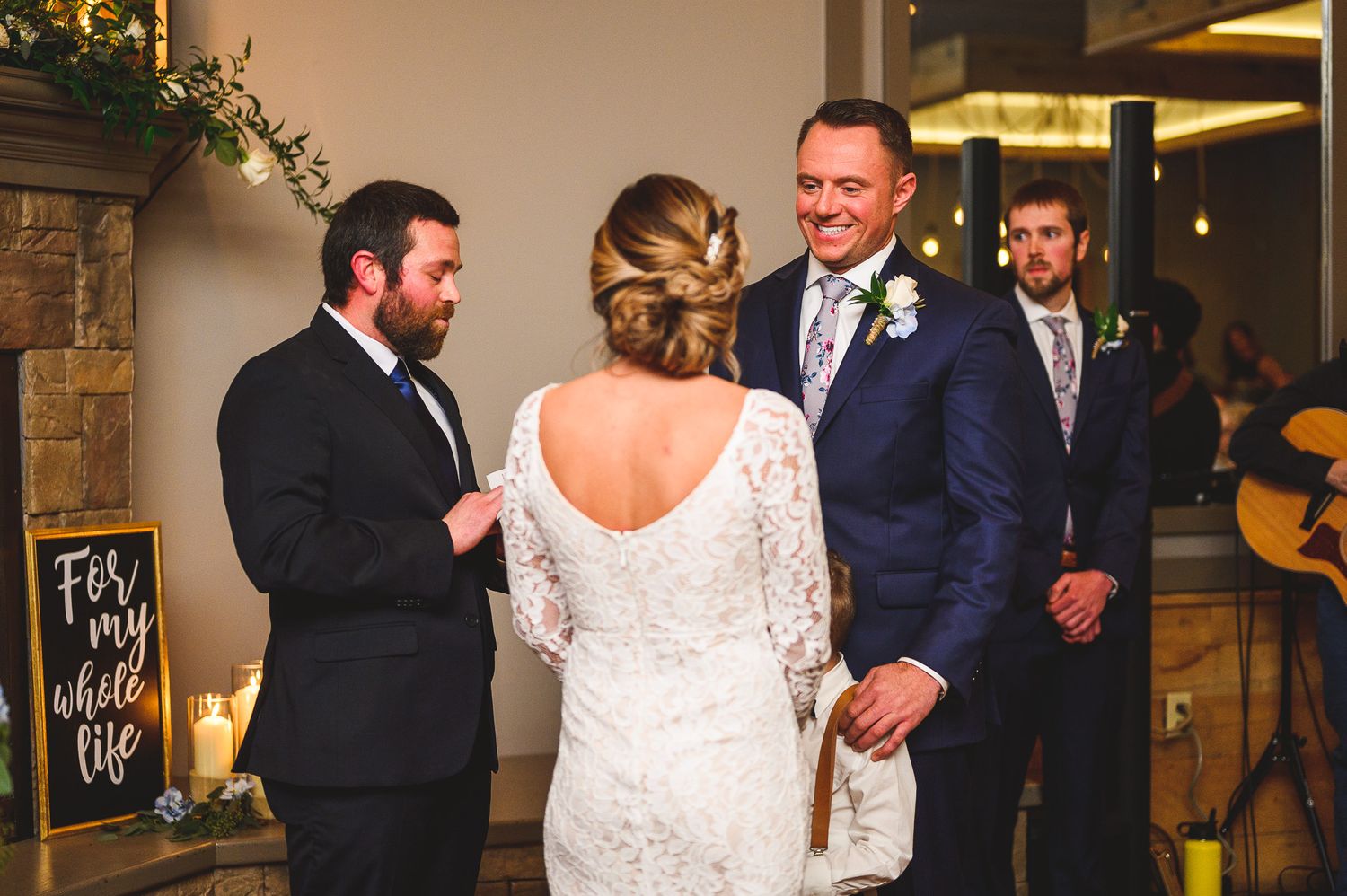 groom smiling at his bride during ceremony