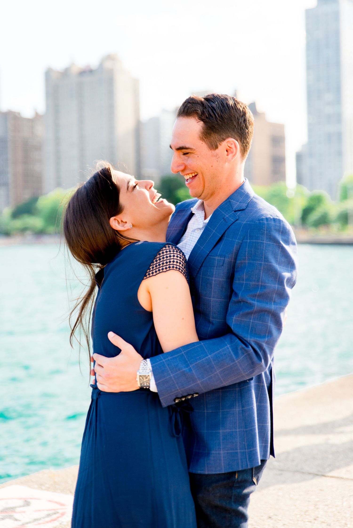 man hugging fiance at North Avenue Beach proposal in the summer