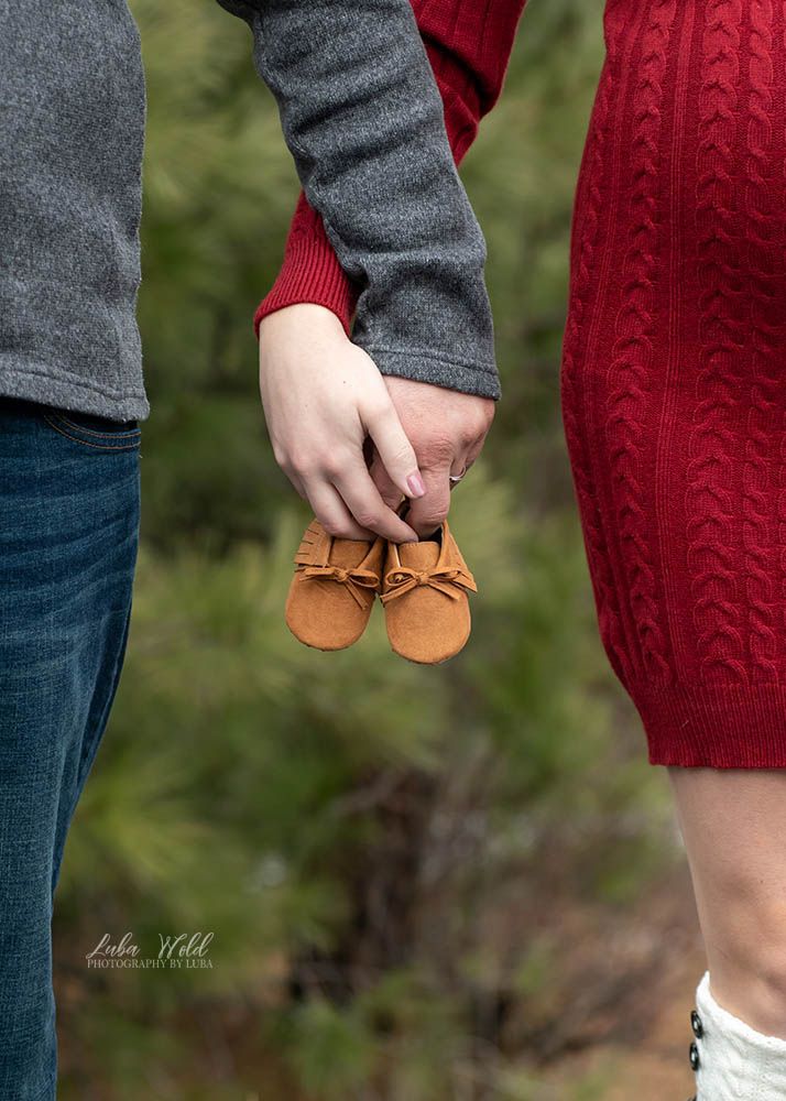 expecting a baby maternity parents hands holding baby shoes red and grey photographer luba wold spokane Coeur d alene