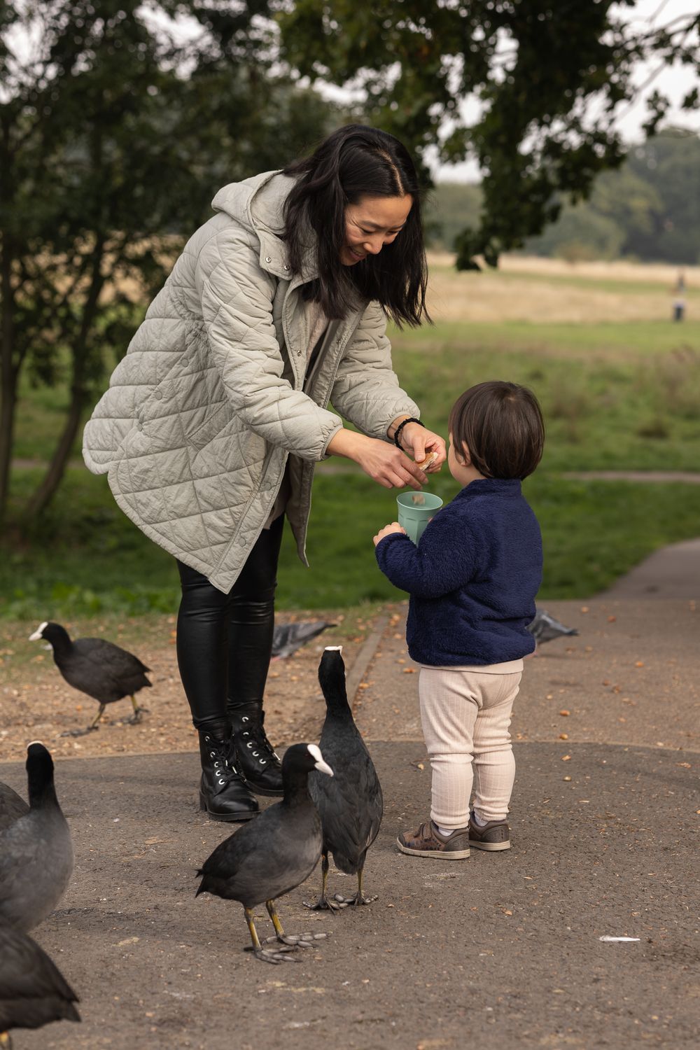Mother and son feeding the ducks in Grovelands Park, Southgate