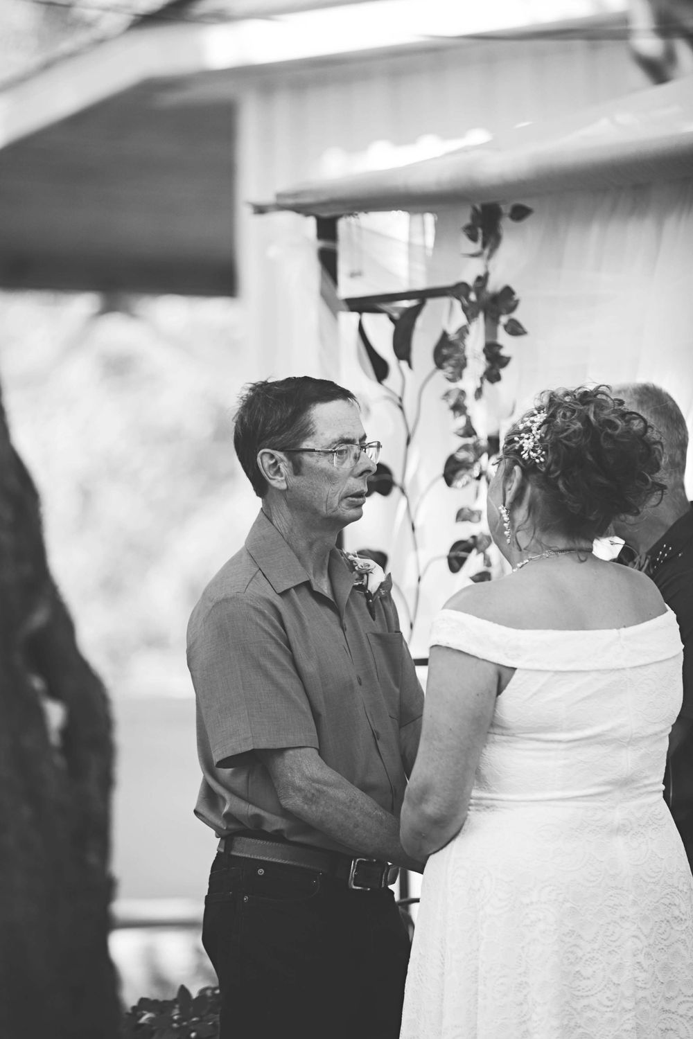 A black and white photo series showing progressive frames of a romantic dance between two people at a wedding reception.