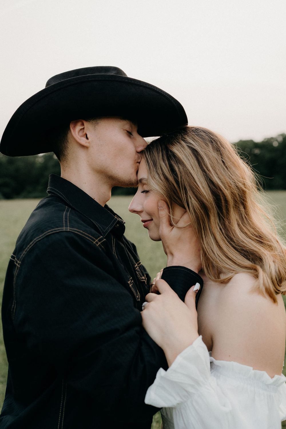 Artistic black and white romantic portrait in a country field setting.