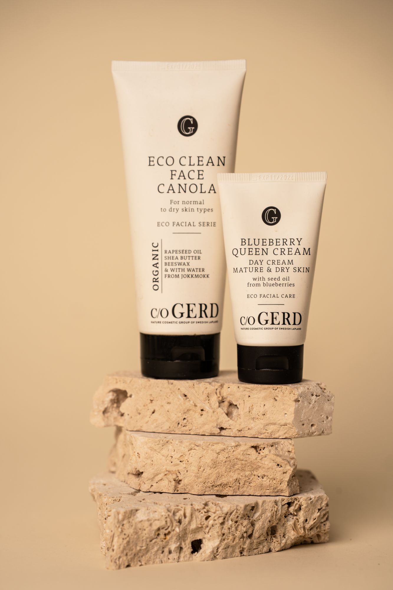 Minimalist skincare products from C.Gerd displayed on textured beige stone platforms in a neutral studio setting.
