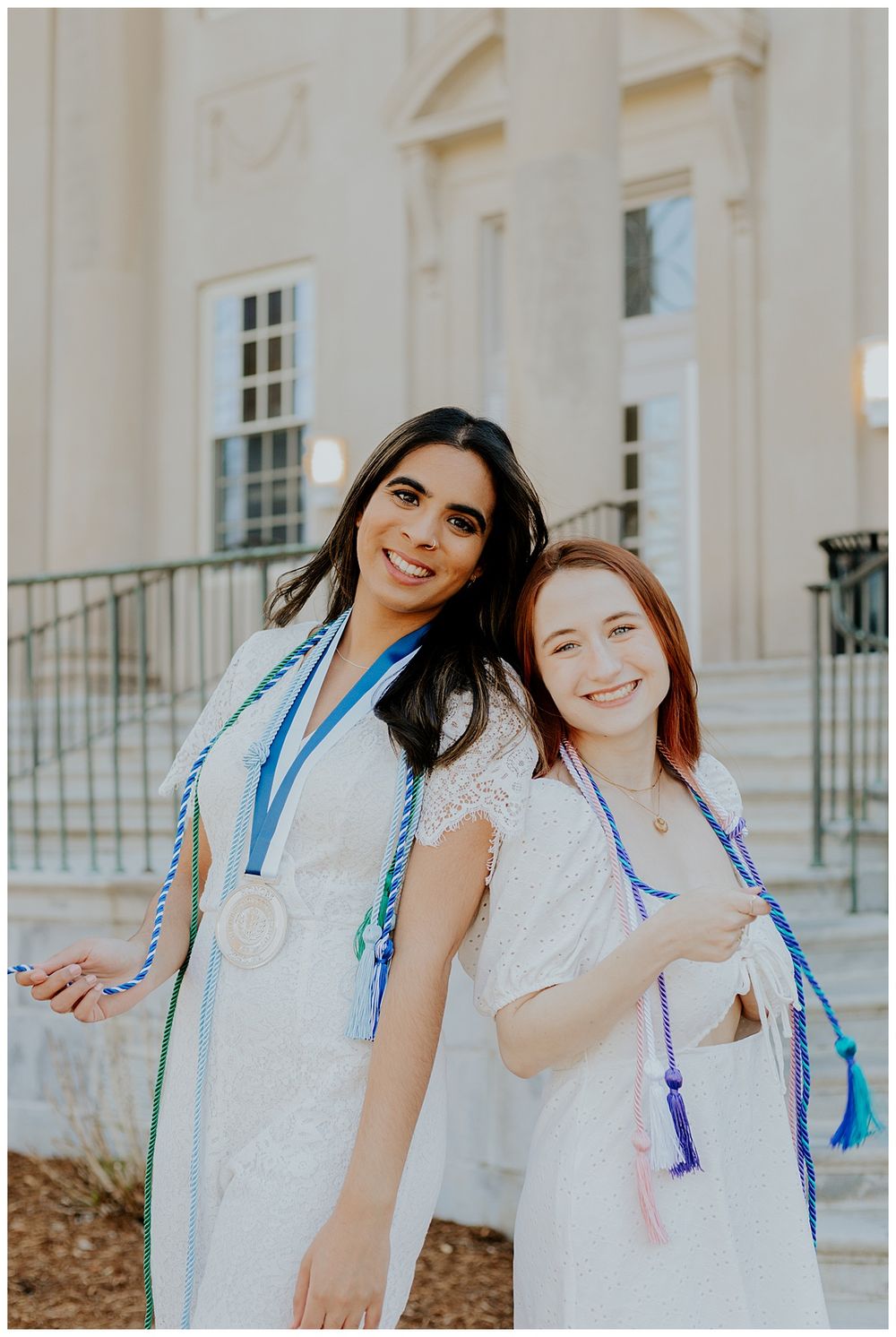 graduates posing with tassels and medals