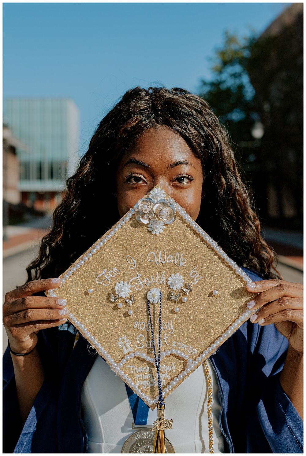 Graduate displays decorated graduation cap with inspirational message.