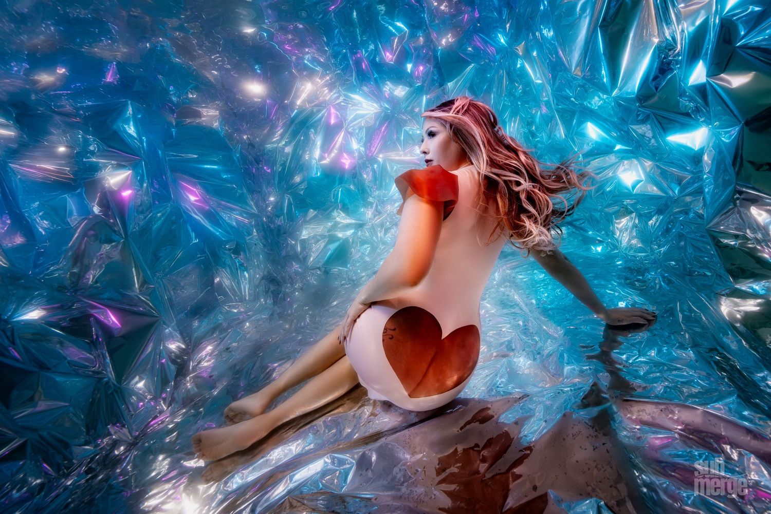 A collection of ethereal underwater photographs showing flowing fabric and dynamic movement in shades of blue and magenta.