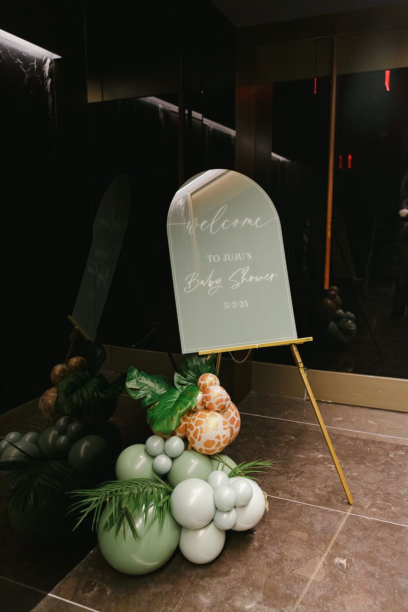 Lush entrance display featuring safari-themed balloons and greenery, welcoming guests to a luxury baby shower in Manhattan