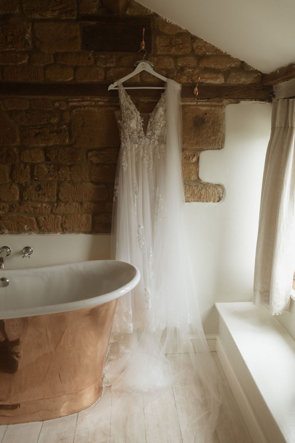 A lace wedding dress hangs at Crockwell Farm wedding