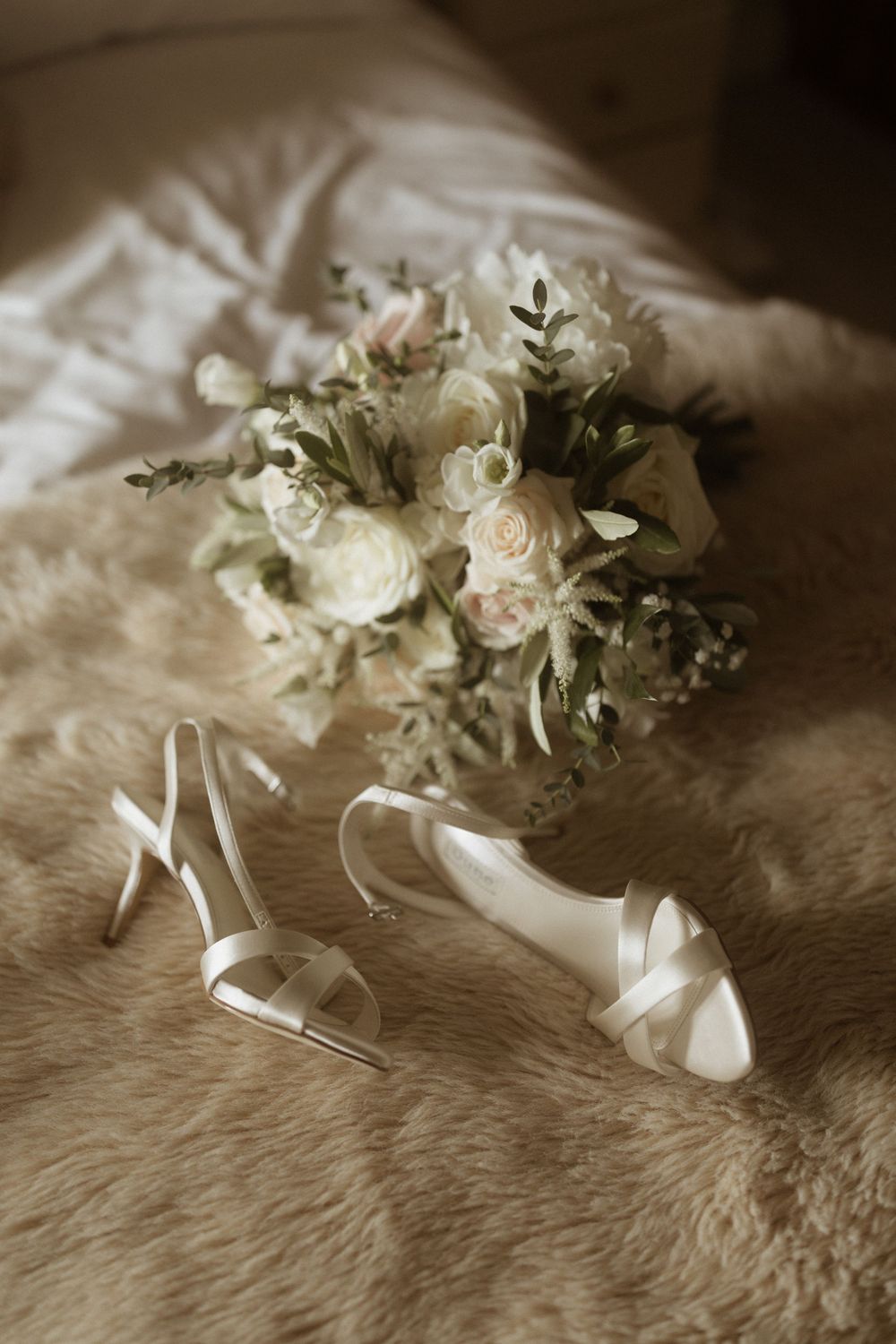 A delicate bridal bouquet of white roses at Crockwell Farm wedding